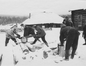 Lyudmila Dubinina working the saw, Spas Devyatov is the tall guy with the hat with white rim looking away form the camera